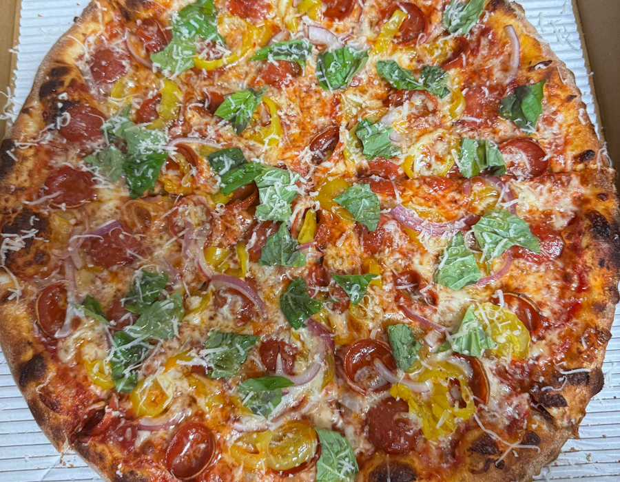 Calabrian Heat pizza with pepperoni, banana peppers, basil, and hot honey
