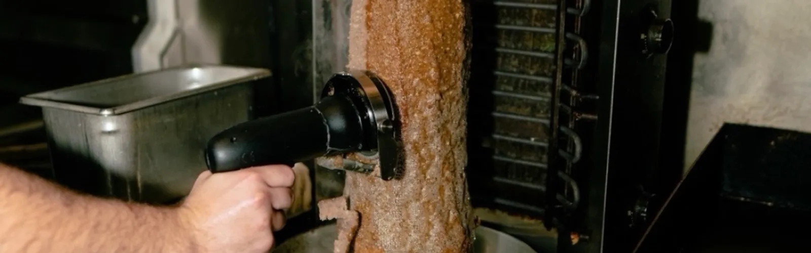 Gyro meat being carved fresh off the rotating spit at Calabria