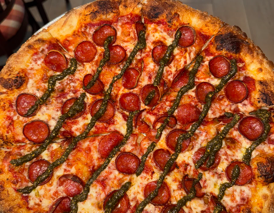 Pesto-Roni pizza with pepperoni and pesto drizzle