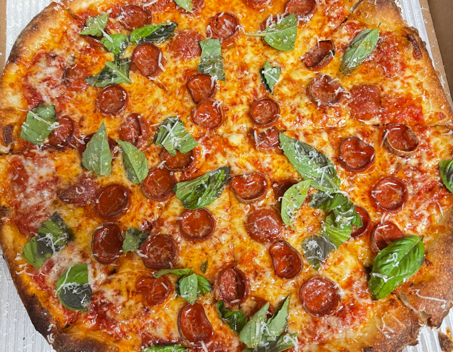 Vodka pepperoni pizza with charred cupped pepperoni, basil, and hot honey