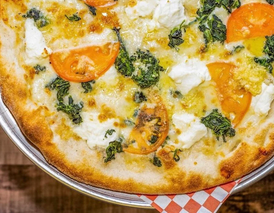 White pizza with ricotta, garlic, and sliced tomatoes